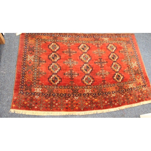 702 - Red ground Eastern fringe rug, 158cm x 102cm.