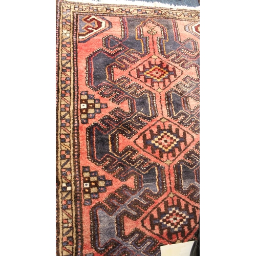 706 - Red and blue ground rug with geometric pattern, 190cm x 103cm.