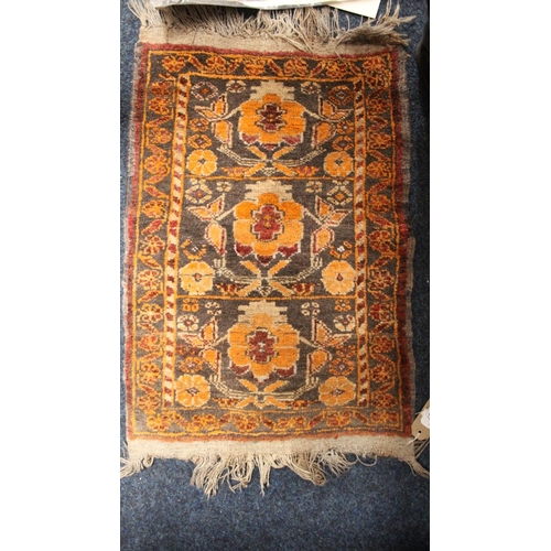 707 - Brown ground small rug with orange floral decoration, 75cm x 48cm.