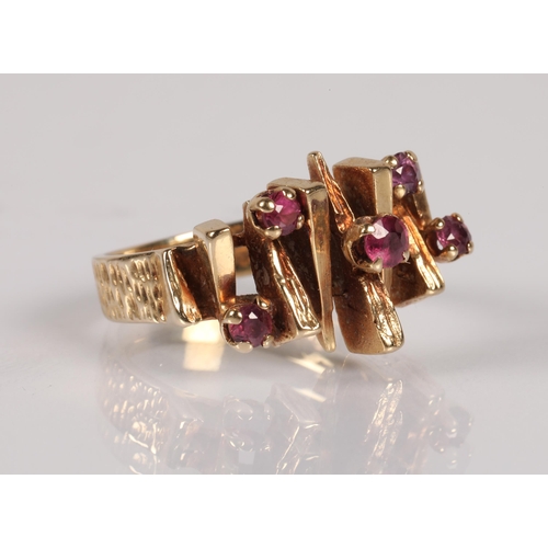 57 - 9ct gold ring in modernist design set with  garnets pink, ring size J, 4.3g