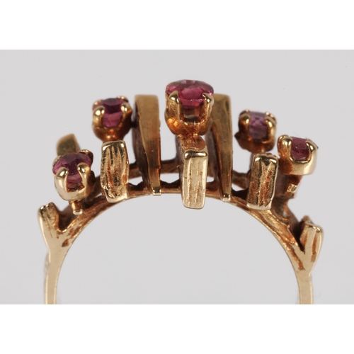 57 - 9ct gold ring in modernist design set with garnets , ring size J, 4.3g