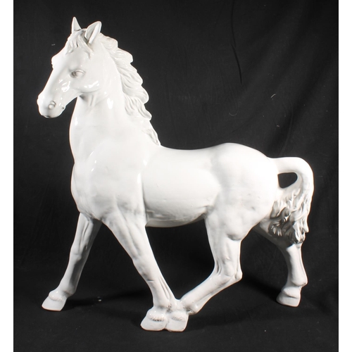 62 - White glazed ceramic model of horse, 59cm high.