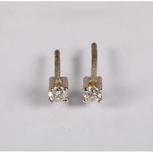 71 - Pair of diamond stud earrings, set in white metal illegibly marked