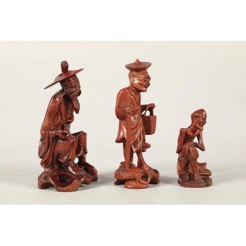 231 - Three Chinese carved wooden figures. Largest 15cm high. (3)