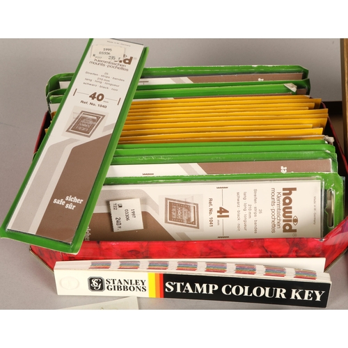 264 - Assortment of mixed empty stamp sleeves and pockets and binder with mail order documents. (2)