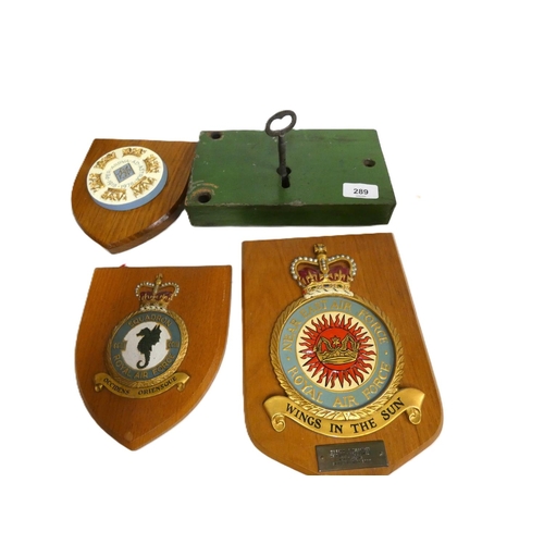 289 - Large antique door lock and three military shields.