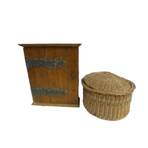 296 - Small oak cupboard and wicker sewing basket.