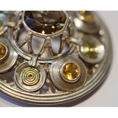 174 - Robert Crerar (Scottish) Silver circular brooch of Celtic shield form with gold and cairngorms, 47mm... 