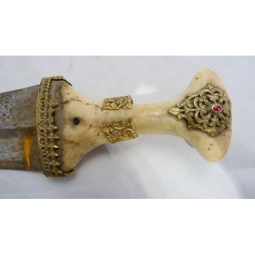 329 - Arabic Jambiya dagger, with bone hilt bearing yellow metal appliques and ruby-coloured jewelled ston... 