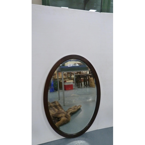 128 - Simulated fur coat and an oval wall mirror.  (2)