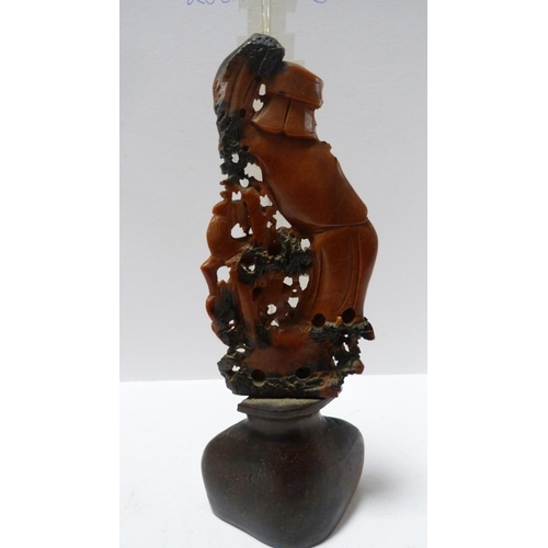 219 - Pair of Oriental soapstone figures in the form of sages with animals, on urn-shaped stands, and a fr... 