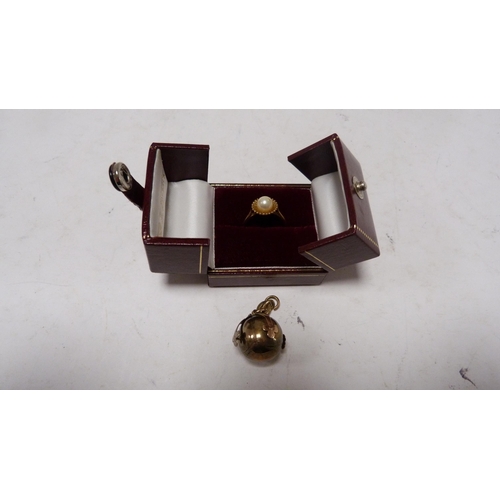 237 - 9ct gold pearl-set ring, 2.5g gross, and a gold-mounted ball pendant.  (2)