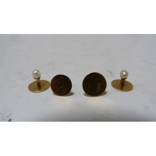 239 - Set of four 9ct gold-mounted dress studs, 4.7g gross.