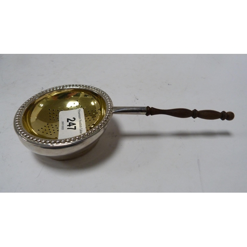 247 - Small silver tea strainer with gilt interior, silver weight 54g, a silver Sauternes spirit label and... 