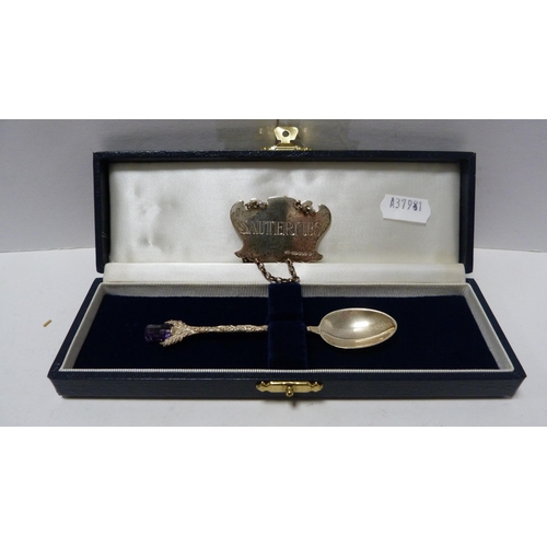 247 - Small silver tea strainer with gilt interior, silver weight 54g, a silver Sauternes spirit label and... 