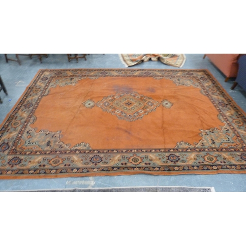 295 - Turkish wool carpet on a rust ground, with green, blue and rust border.