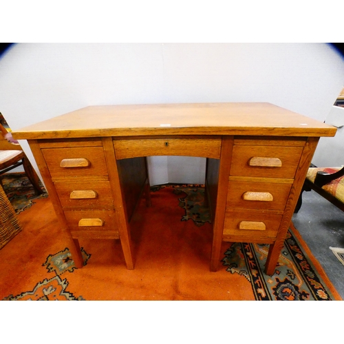 296 - Golden oak kneehole desk.