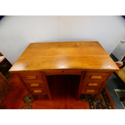 296 - Golden oak kneehole desk.