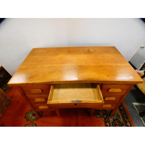 296 - Golden oak kneehole desk.