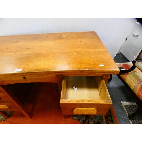 296 - Golden oak kneehole desk.