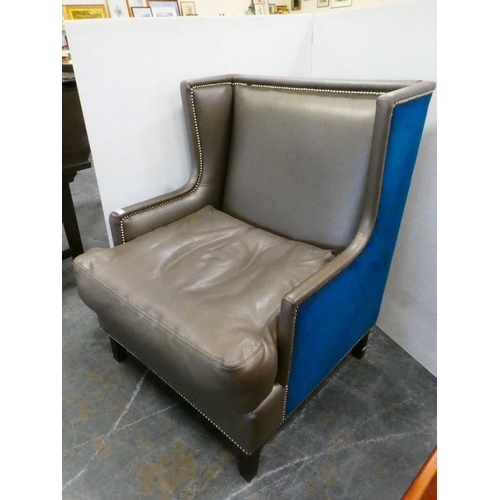 309 - Contemporary wing armchair upholstered in blue velour and hide.