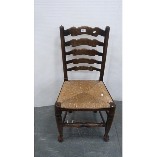 312 - Rush-seated ladder-back antique chair and two woven stools.  (3)