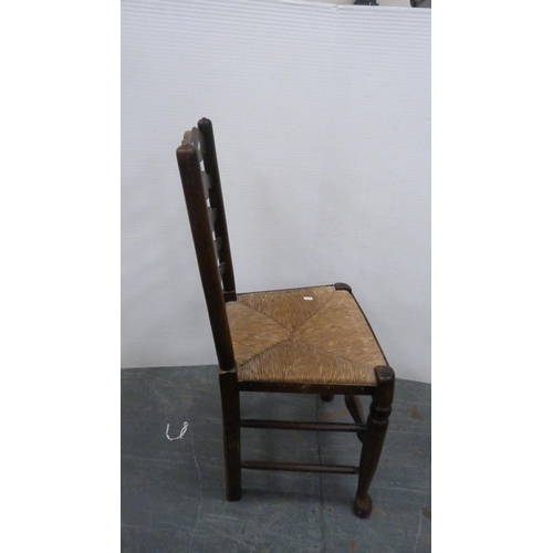 312 - Rush-seated ladder-back antique chair and two woven stools.  (3)