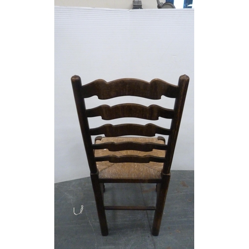 312 - Rush-seated ladder-back antique chair and two woven stools.  (3)