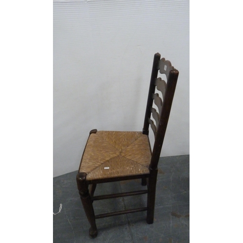 312 - Rush-seated ladder-back antique chair and two woven stools.  (3)