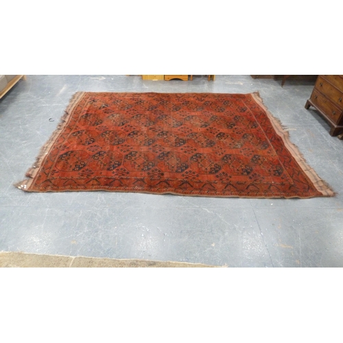 327 - Afghan-style Belouch carpet with rows of geometric medallions on a red ground.