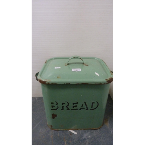 351 - Green enamel bread bin and cover, large metal kitchen jug and two stoneware pigs.  (4)