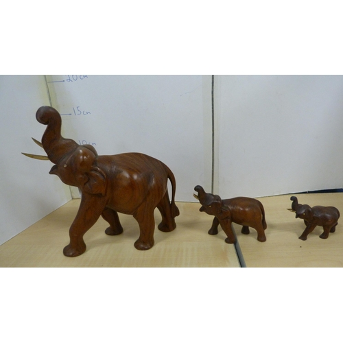 53 - Group of treen and wood items to include elephant figures, fruit, Indian-style dish, brass pot, wick... 