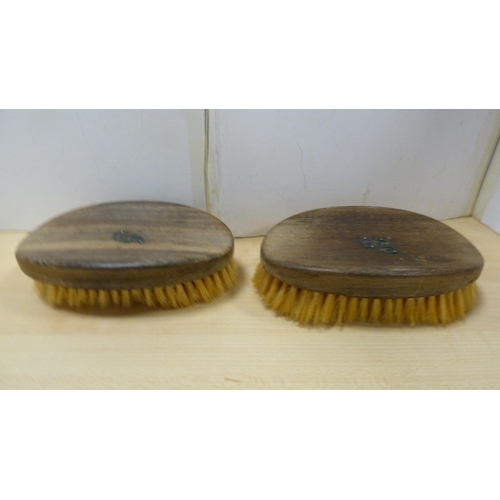 79 - Group of clothes brushes to include two silver backed brushes.