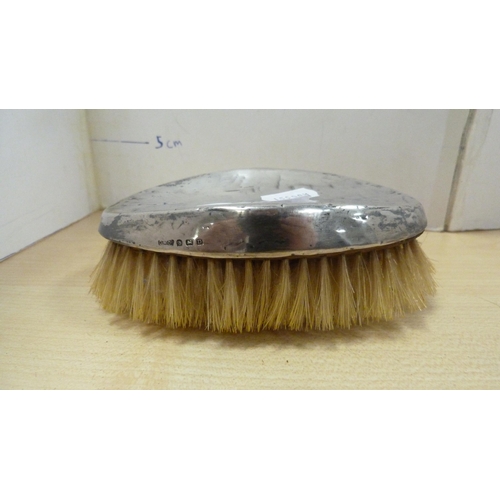 79 - Group of clothes brushes to include two silver backed brushes.