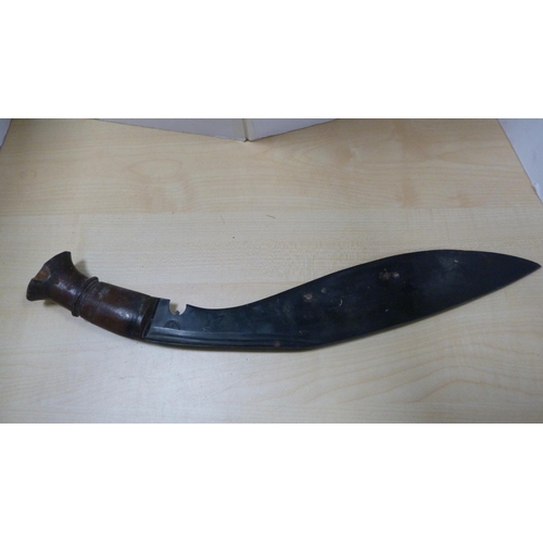 80 - Two kukri daggers with wooden grips.