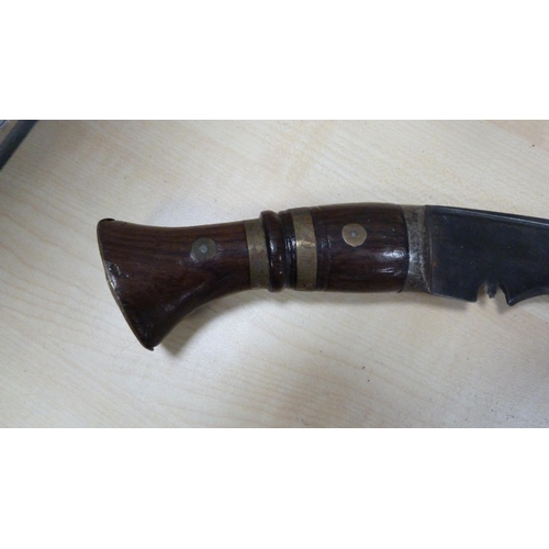 80 - Two kukri daggers with wooden grips.