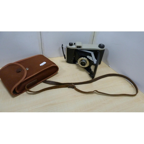 86 - Bowler hat by Moore's of London, folding camera, Ilford camera and a pair of wooden candlesticks.