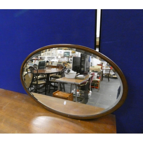 493 - Oval mahogany wall mirror.