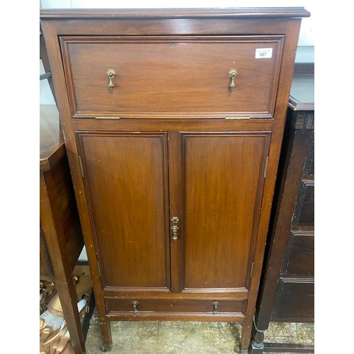 687 - Mahogany double door cabinet on casters, with flip-down compartment and drawer