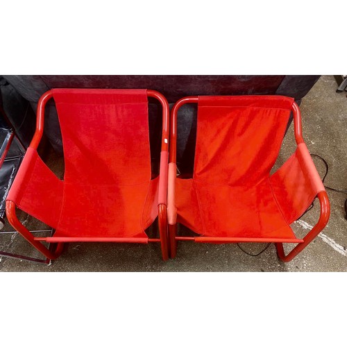 676 - Two red metal-frame designer chairs (2)