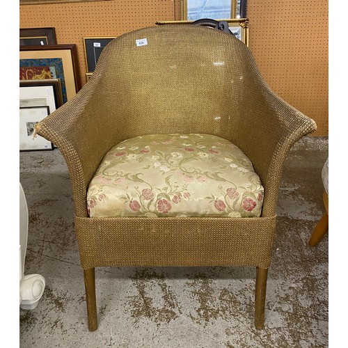 630 - Lloyd loom style arm chair with floral upholstery