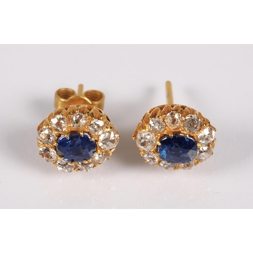 107 - Pair yellow metal stud earrings set with a central sapphire surrounded by diamonds, gross weight 2.3... 