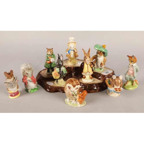 183 - Ten Beswick Beatrix Potter figurines with display base