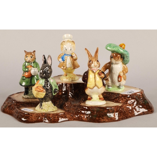 183 - Ten Beswick Beatrix Potter figurines with display base