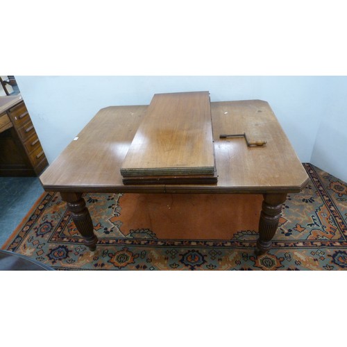 294 - Mahogany extending dining table with two additional leaves.