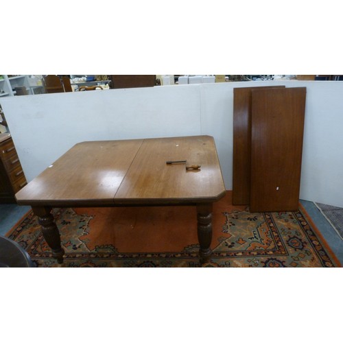 294 - Mahogany extending dining table with two additional leaves.