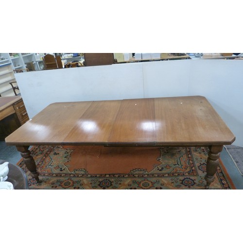 294 - Mahogany extending dining table with two additional leaves.