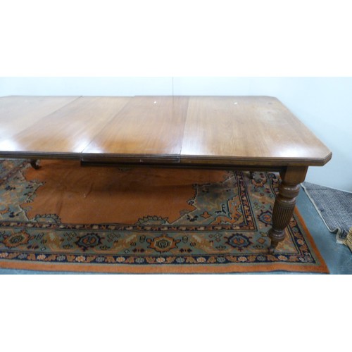 294 - Mahogany extending dining table with two additional leaves.