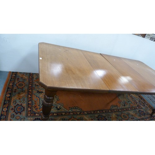 294 - Mahogany extending dining table with two additional leaves.