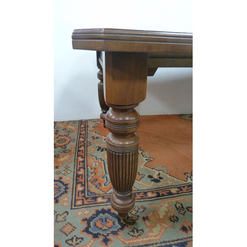 294 - Mahogany extending dining table with two additional leaves.